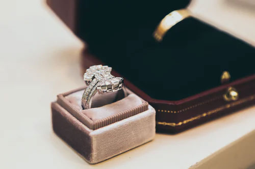 Diamond Ring in a mauve colored ring box on tabletop