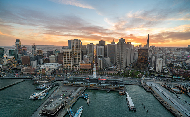 The San Francisco skyline with the sun setting behind.