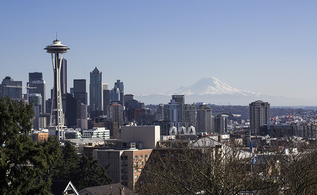 The Seattle skyline with a huge mountain in the background.