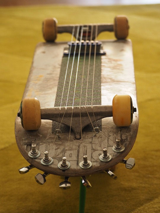 A skateboard made into a guitar as an idea for an upcycling business