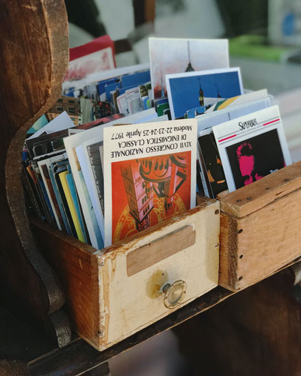 A box of antique postcards for sale as an example of the best garage sale finds