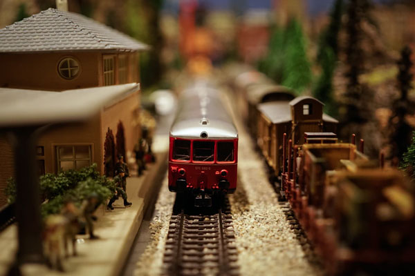 A model train stops at a model train station