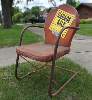 garage sale sign on a chair