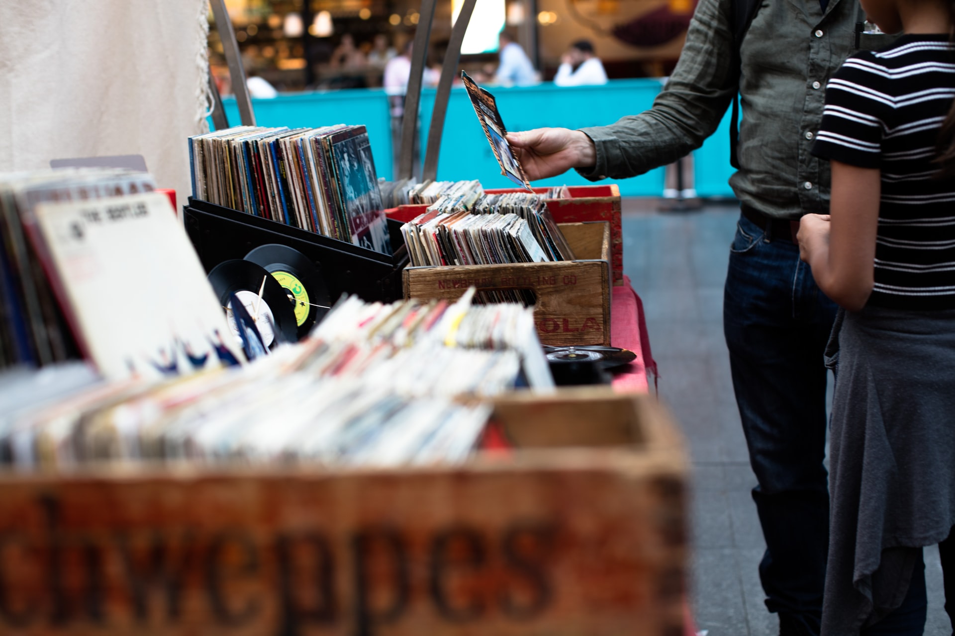 Two people shopping for used records at a yard sale.