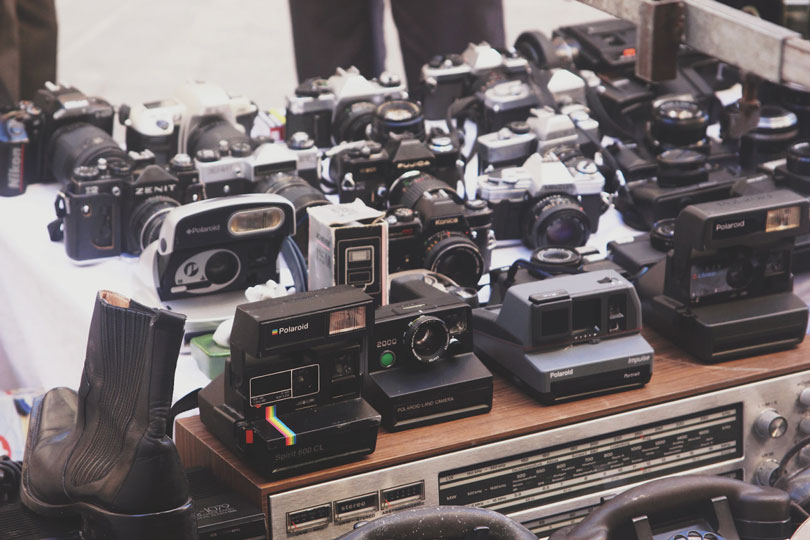 A table full of old electronics as an example of the best yard sale items to sell